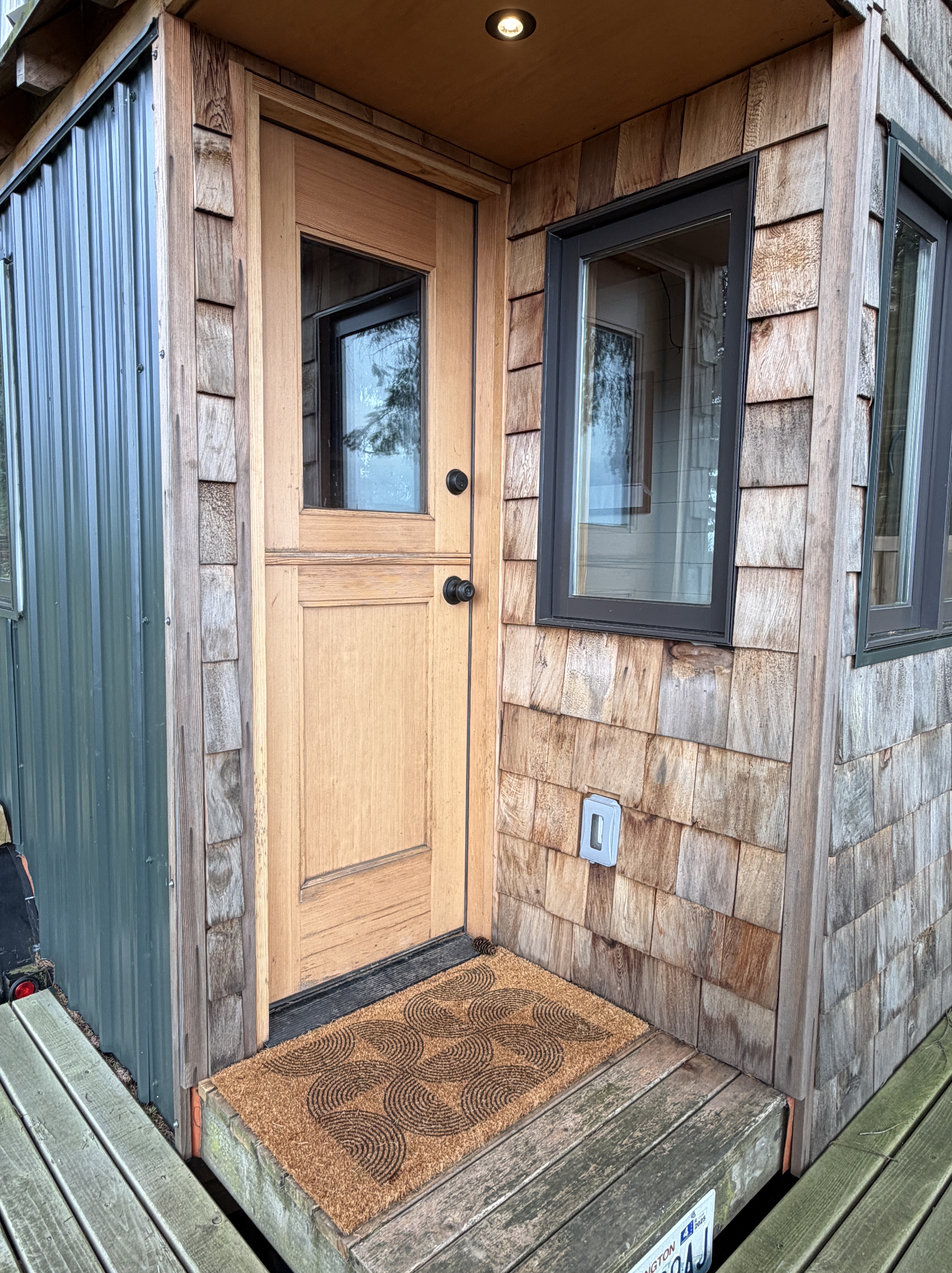 Front door of the Huckleberry Hut with reclaimed wood siding