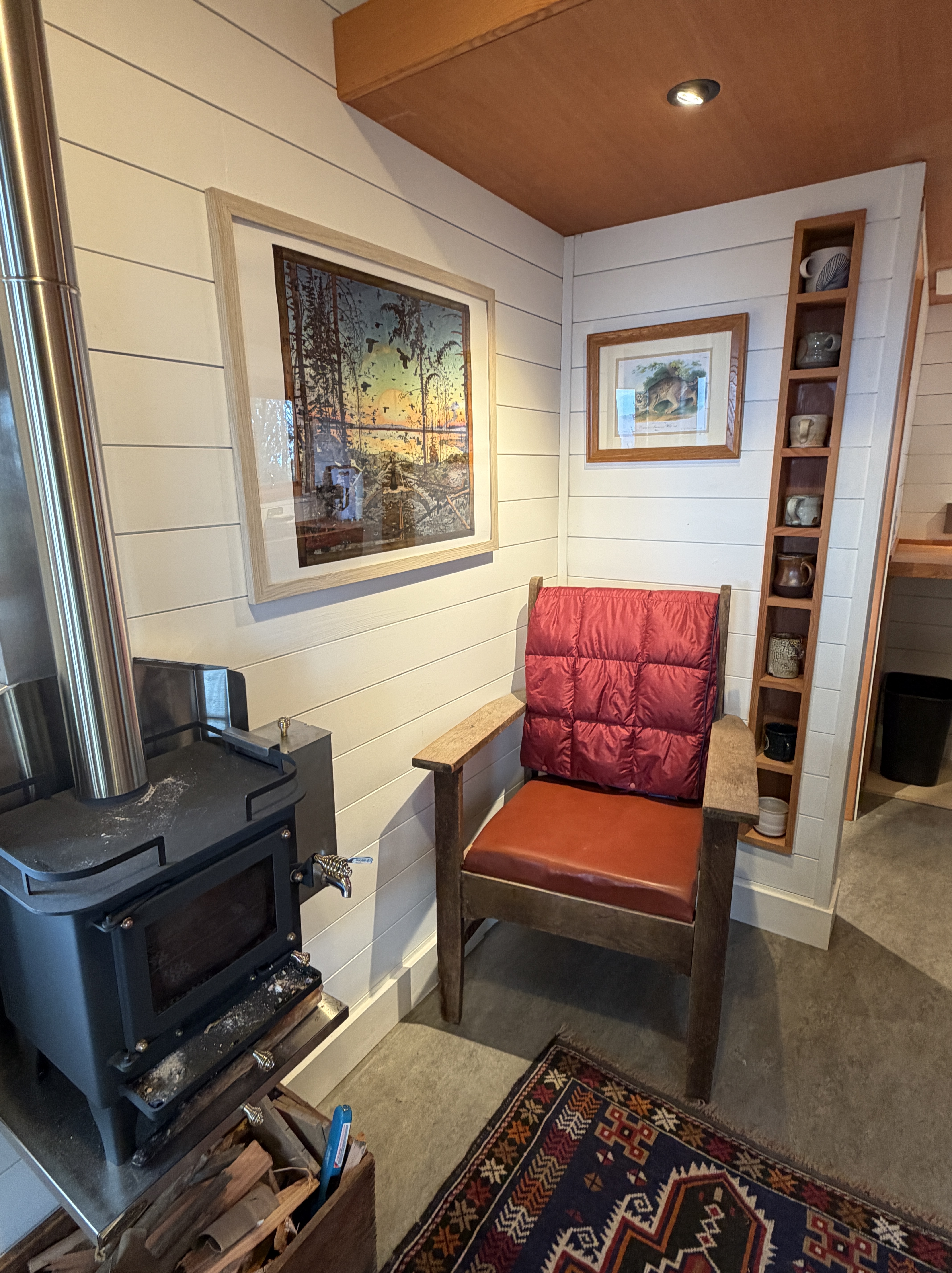 Wood stove and reading chair in the Huckleberry Hut living room